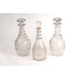 A pair of cut glass triple-ring neck decanters and stoppers,