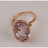 A kunzite and diamond dress ring set in 18ct yellow gold,