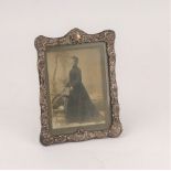 A Victorian silver photograph frame, Birmingham 1900, the surround embossed C scrolls,