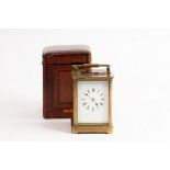 A gilt brass cased carriage clock, the white enamel dial with Roman numerals,