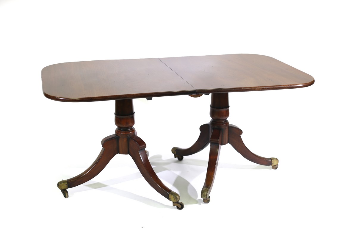 A Regency style mahogany twin pedestal dining table,