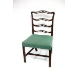 A mahogany ladder back chair with upholstered seat on moulded chamfered legs