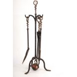 An Arts and Crafts style fireside companion set, the stand of tripod form,