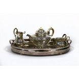 A matched three-piece silver tea set, Victorian and later, on an oval silver plated tray, 48.