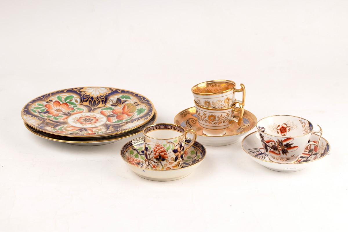 A pair of Coalport Imari pattern plates, circa 1810, together with a similar coffee can and saucer,