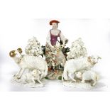 A pair of Derby gilt and white porcelain models of a ram and ewe with lambs,