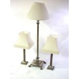 A silvered brass Corinthian column telescopic standard lamp and a pair of silvered table lamps