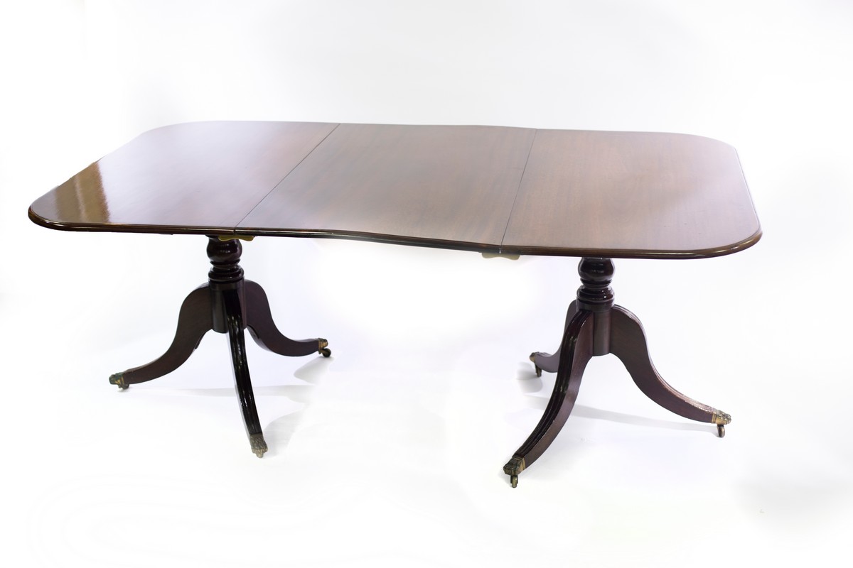 A Regency style mahogany dining table, of twin pedestal form with two leaves, the top 245.