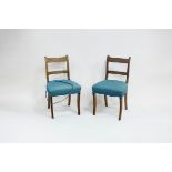 A pair of Regency mahogany single chairs with horizontal splats and upholstered seats,
