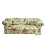 A Victorian upholstered Chesterfield settee with a deep button back on turned front legs,
