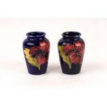 A pair of Moorcroft vases of baluster form, painted flowers, 9.