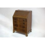 A mahogany bureau fitted a fall flap with four drawers beneath, on claw feet,