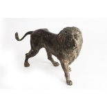 A bronze figure of a standing lion,