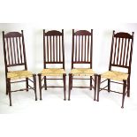 A set of four Arts and Crafts style kitchen chairs, with vertical rail backs,