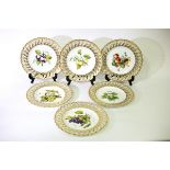 A set of six Coalport plates painted fruit within gilt pierced borders,