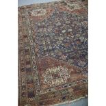 A Hamadan rug with central blue ground, geometric field and medallion to the corners,