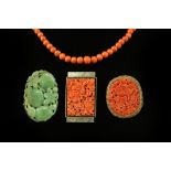A carved jade brooch modelled as pumpkins, in an oval frame marked 'silver', 53mm wide,