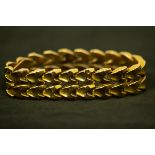 An 18ct yellow gold bracelet composed of two rows of V shaped links, 19cm long, approximately 42.