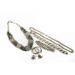 Two silver necklaces, two bracelets, a brooch and a pair of ear clips,
