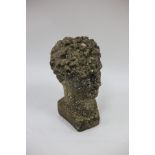 A reconstituted stone bust of a youth,