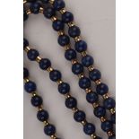 A lapis bead necklace, the circular beads with yellow metal spacers, to a 9ct gold snap,