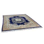A Chinese carpet, the central floral medallion to a royal blue ground within a floral border,