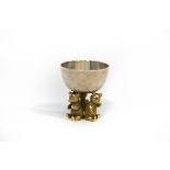 A silver and silver gilt egg cup, IP, London 1990, the cup on a support of three bears, 5cm high,