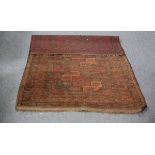 A Turkoman rug with three geometric medallions to the red ground, 178cm x 117cm,