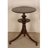A 19th Century oak tripod table with lower tier, the circular top,