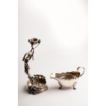 A sterling silver bottle holder, the handle of figural form, 26.5cm high, approximately 587gm and