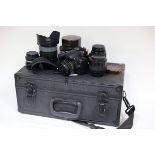 A Nikon D40 camera with accessories in a carry case and two vintage Kodak cameras