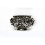 A Chinese double walled silver bowl, the exterior decorated water lilies in high relief, 17.