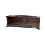 A 17th Century Italian walnut carved and panelled cassone with carved and painted central coat of