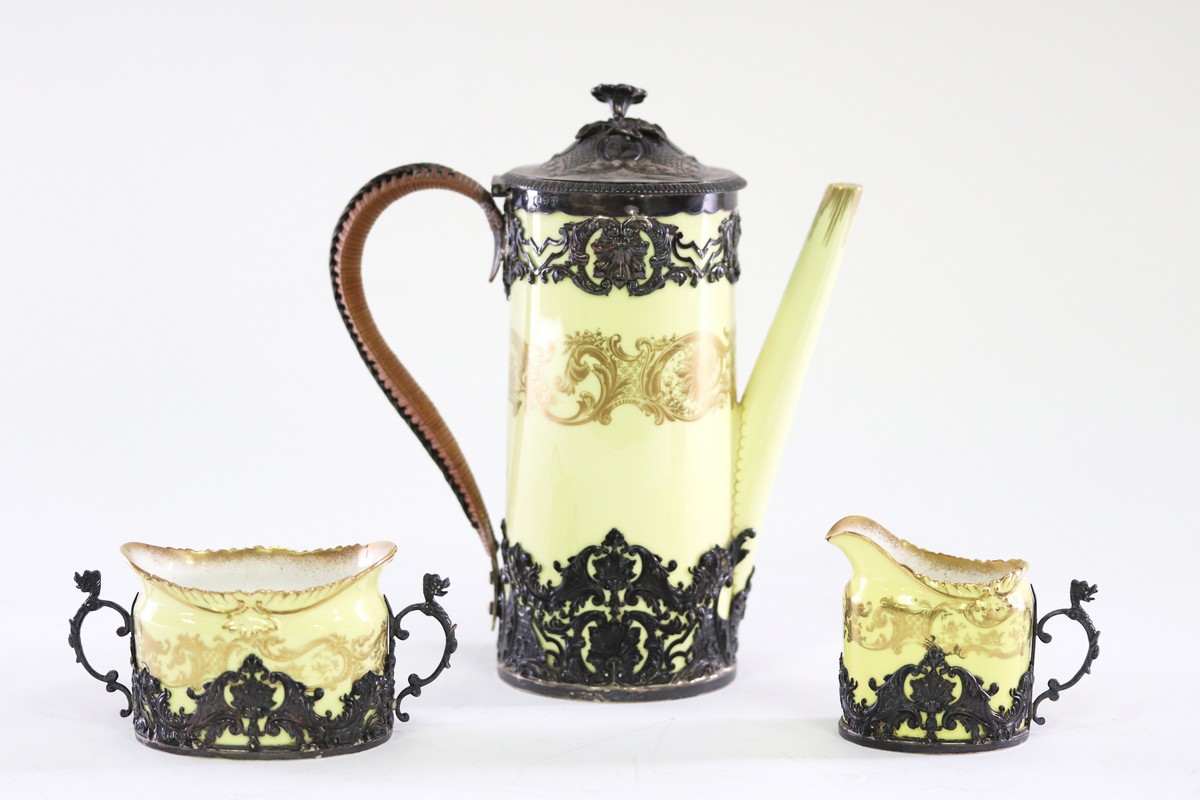 A Royal Worcester silver mounted coffee pot, sugar basin and cream jug, the mounts Adie Bros.