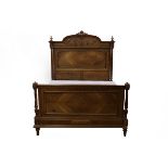 An early 20th Century walnut bed,