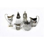 A George III silver cream jug, London 1799, of helmet shape, two further jugs, a silver caster,