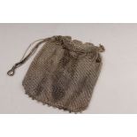A silver mesh evening bag with draw strings and tasselled fringes