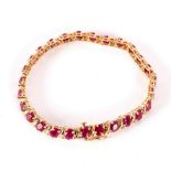 A ruby and diamond bracelet, set in 14k yellow gold,