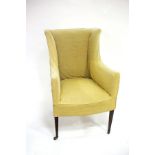 A George IV square framed wing back armchair on square taper legs