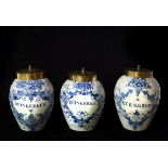 Three Delft tobacco jars, late 18th Century, with brass covers,