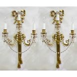 A pair of gilt metal three-branch wall sconces,