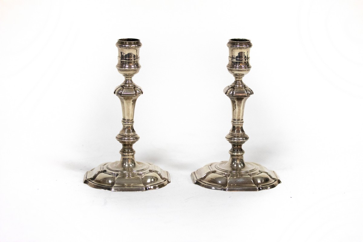 A pair of 18th Century style cast silver candlesticks, CJ Vander, London 1977/1979, of knopped form,