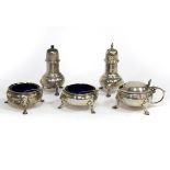 A matched silver cruet set comprising two silver cauldron salts, London 1980, a similar mustard