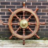 A brass mounted eight-point ships wheel, 91.