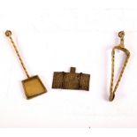 A Russian brass triptych and two miniature brass fire irons modelled as a shovel and tongs