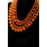Three amber bead necklaces and an agate bead necklace