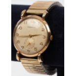 A gentleman's 9ct gold cased wristwatch, the dial inscribed Garrard, with articulated strap,