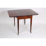 An early 19th Century mahogany Pembroke table, fitted a drawer on square taper legs with castors,