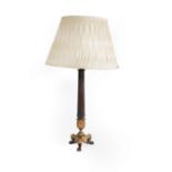 An Empire style table lamp with bronzed metal fluted column and gilt metal triform base,