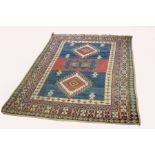 A Hamadan rug, the central blue ground field with two medallions within a multi figured border,